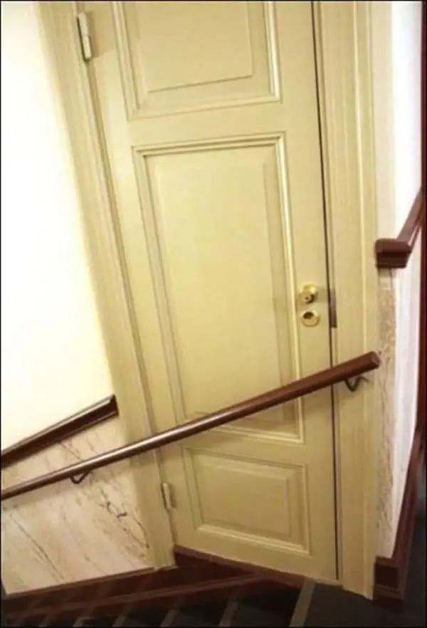 door being blocked from opening by hand railing on stairs 