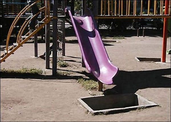 purple slide that leads to concrete hole 