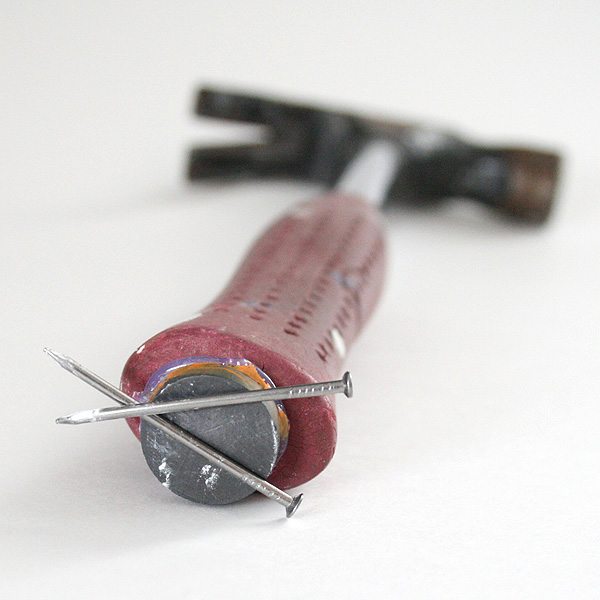 magnet glued on hammer holds nails