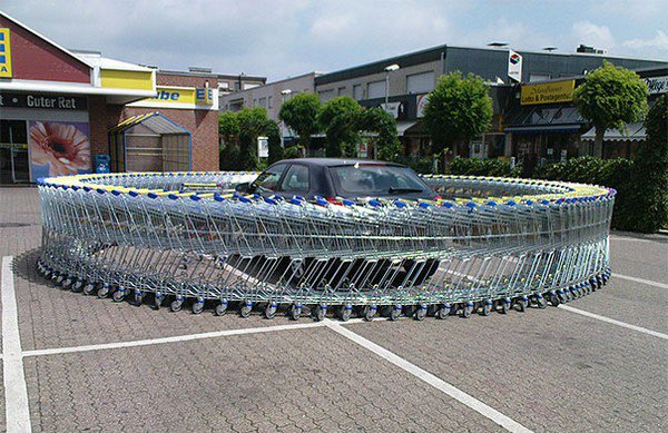 A loop of shopping carts around a car