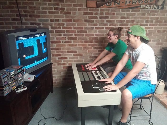 nintendo nes controller coffee table couple playing