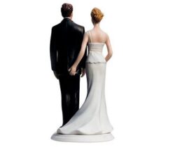 bride pinching groom cake topper