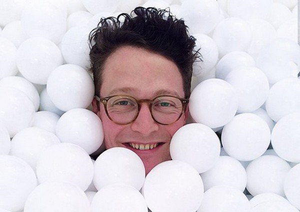 man glasses smiling balls