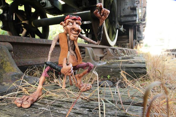 troll-sculpture-train-tracks