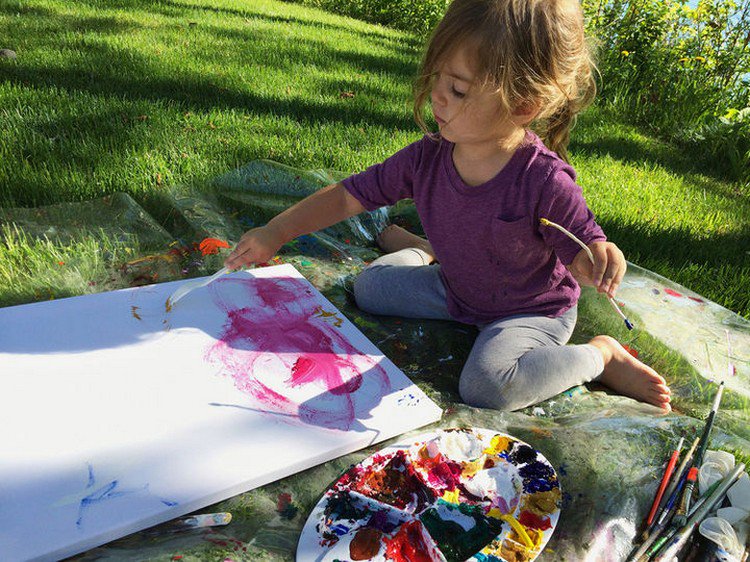 girl painting grass