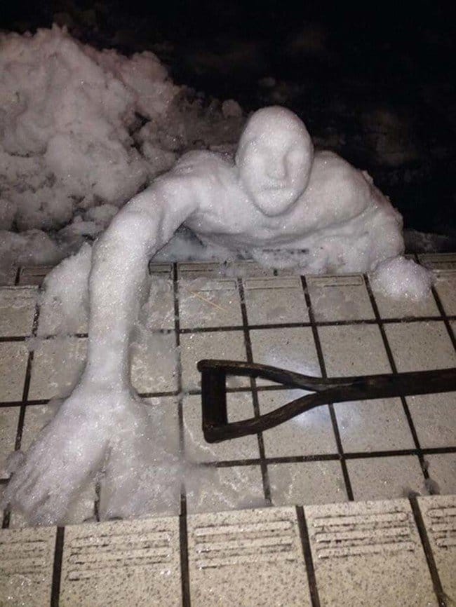 snowman reaching for shovel