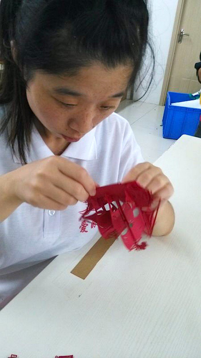 girl assembling paper boat
