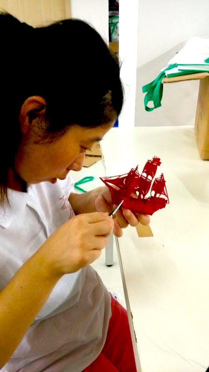 girl working on paper boat