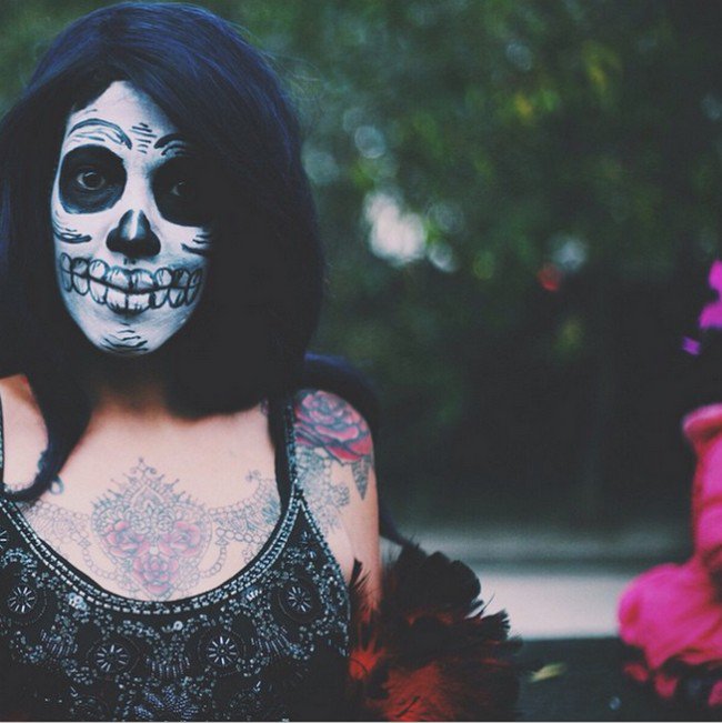black hair tattoed woman skull makeup