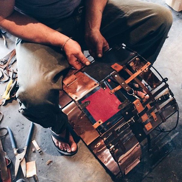 man working on leather copper shade