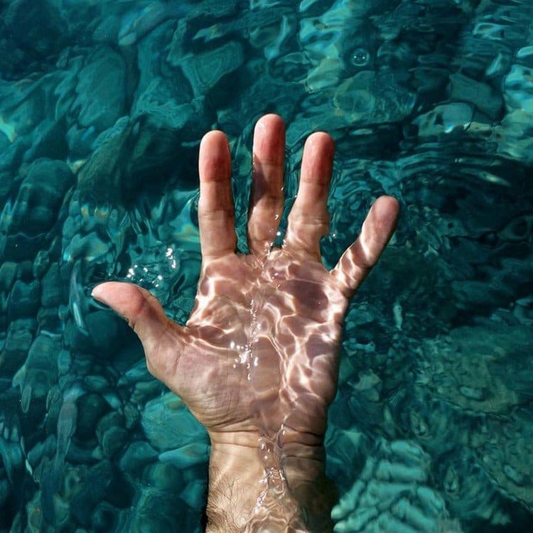 hand blue water