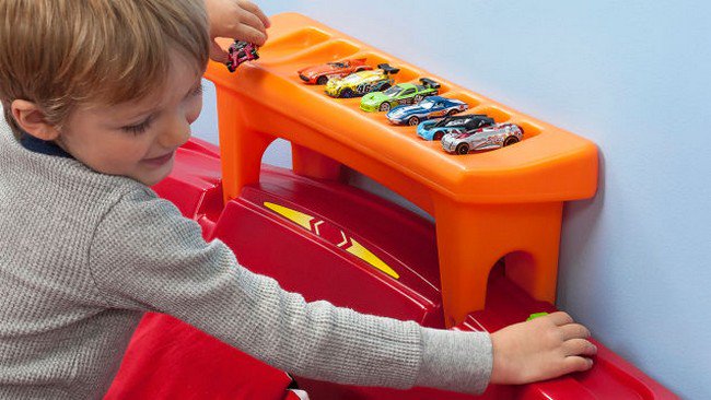 boy playing cars hot wheels bed