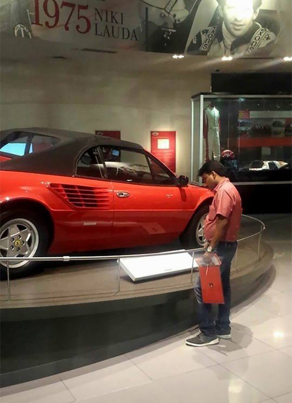 man looking at car