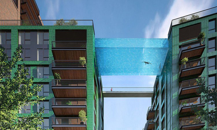 person swimming glass bottom pool