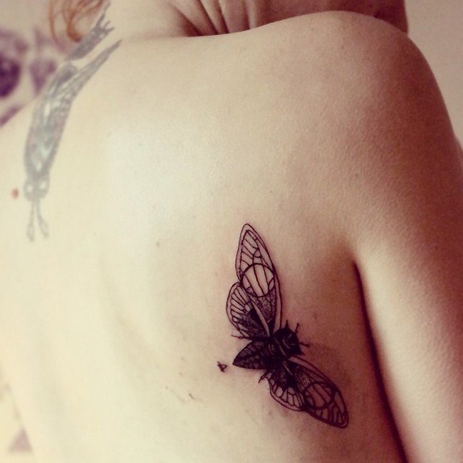 winged insect tattoo