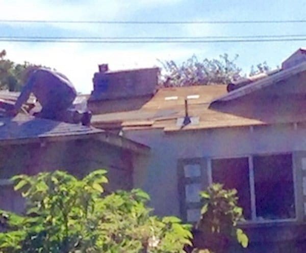 elderly man fixing roof