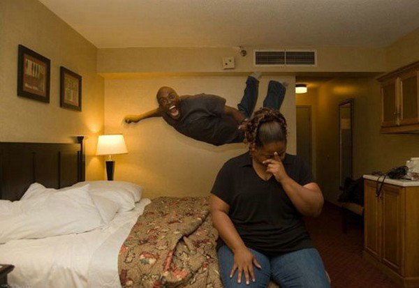 guy jumping hotel bed