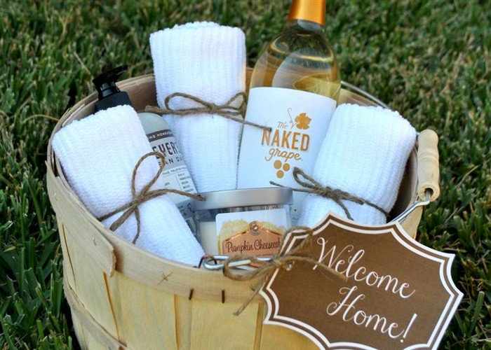 basket filled with wine towels soap and candle