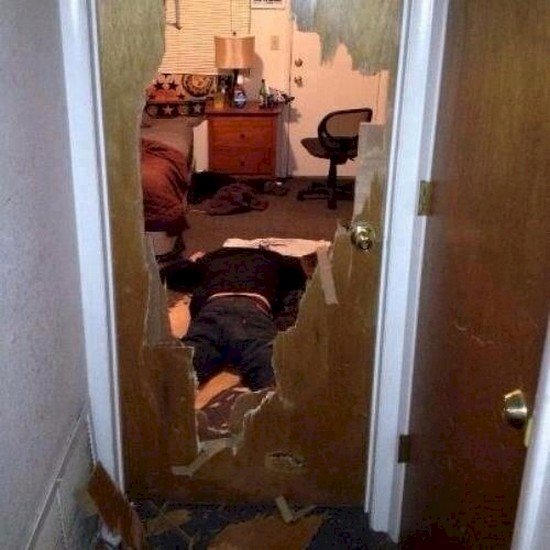 man breaks through door