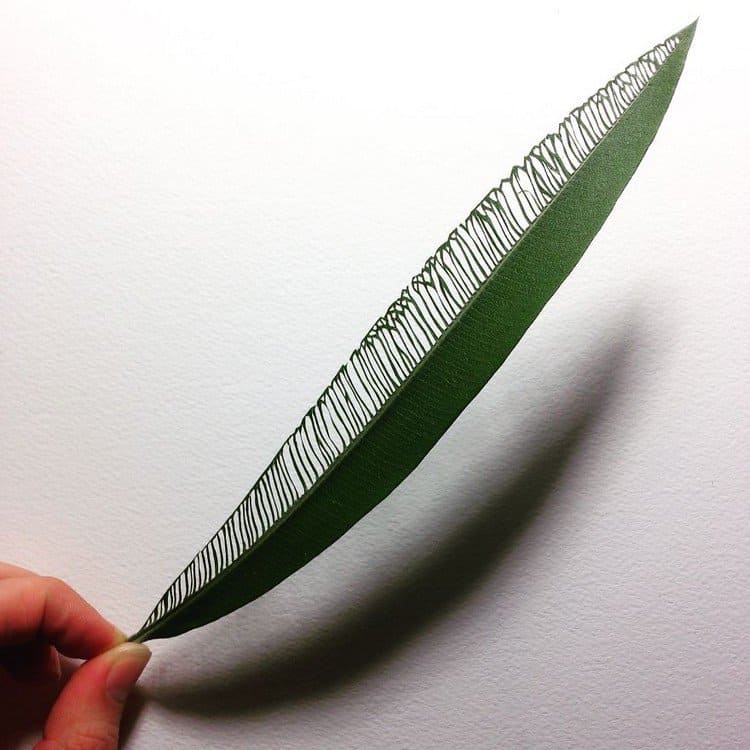 hand holding embroidered leaf art