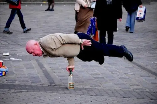 man balancing bottle