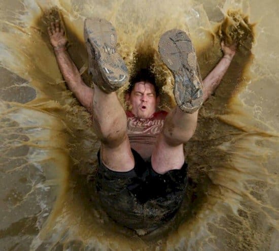 man falling into muddy pool