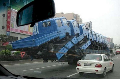 trucks balanced over road