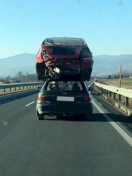 wrecked car on traveling car