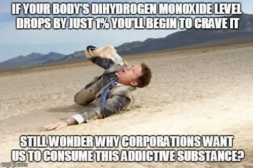 man lying on desert floor with water bottle in hand and water addiction fact 