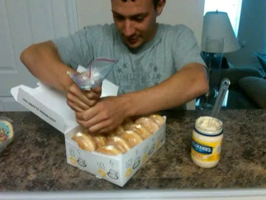 guy filling donuts with mayonnaise 