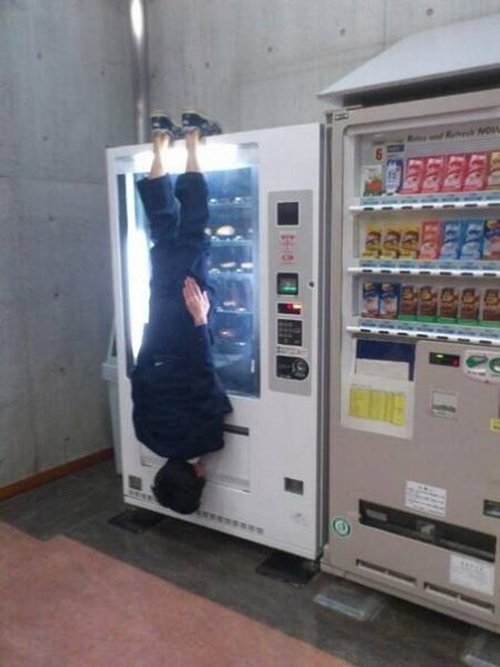 only-in-asia-hanging-from-vending-machine