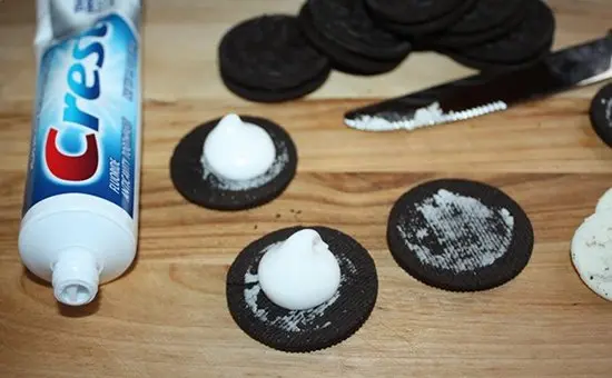oreos filled with toothpaste next to crest tube