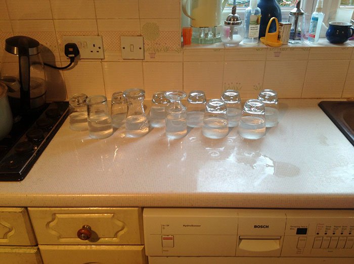 sibling pranks upside down glasses with water