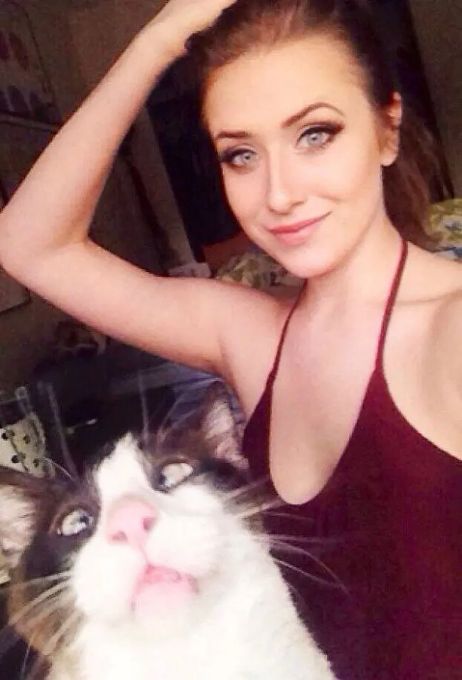 funny cat photobombs posing girl cat foreground