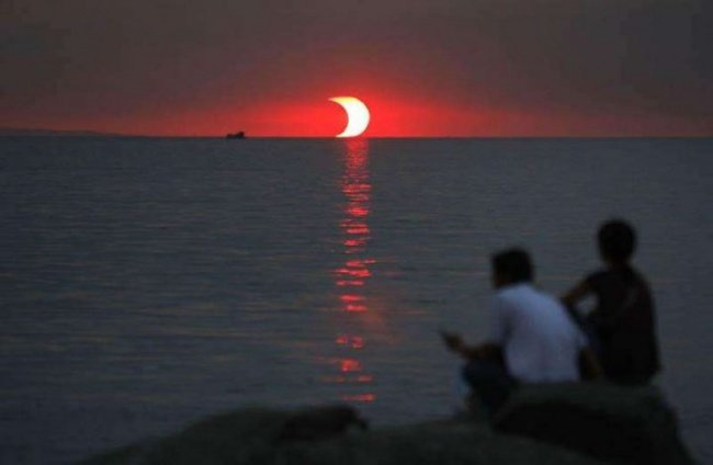 sunset and eclipse happening at the same time