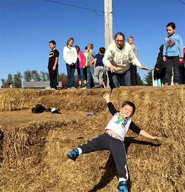 boy slipping on hay