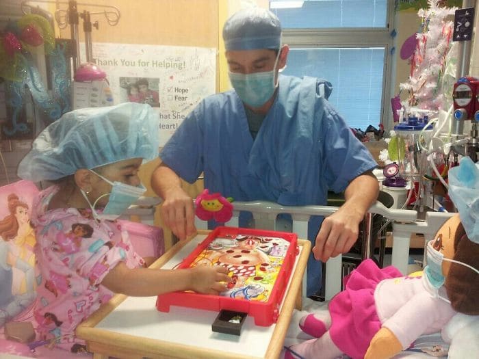 little girl playing operation in hospital