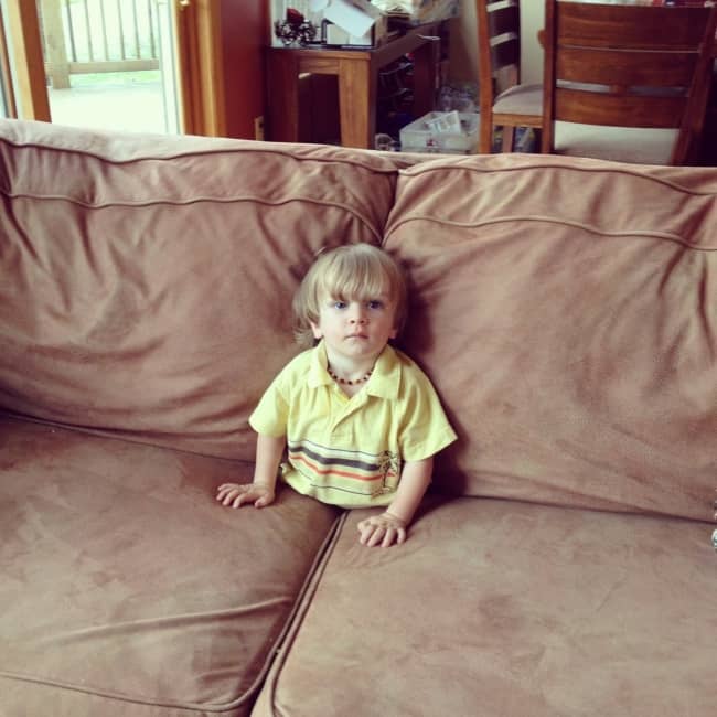 Kids Being Strange sitting inside sofa