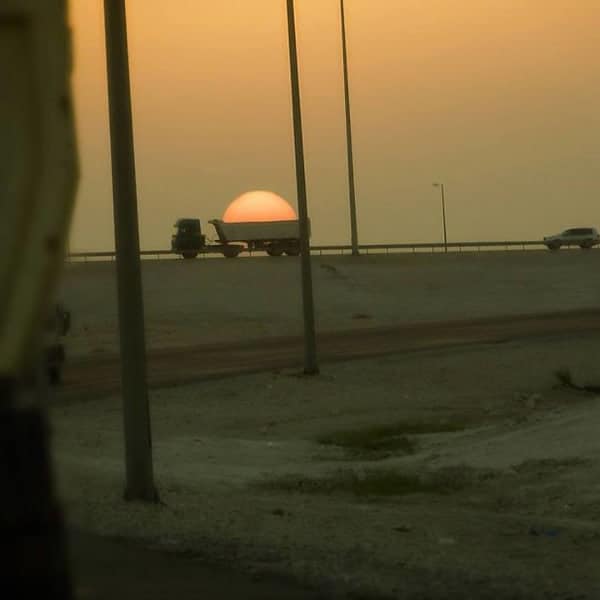 Perfectly Timed Photos lorry carrying sun