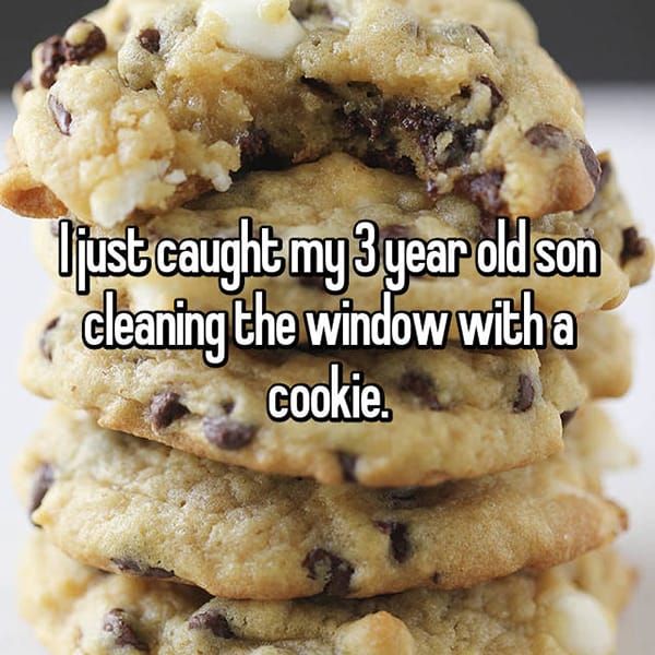 Strangest Things Their Toddlers Have Done cleaning window with cookie
