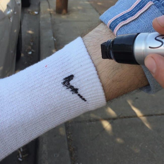 using-a-marker-to-put-brand-to-socks
