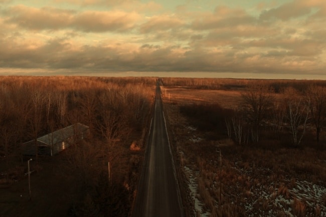 long-road-across-a-forest-at-sundown
