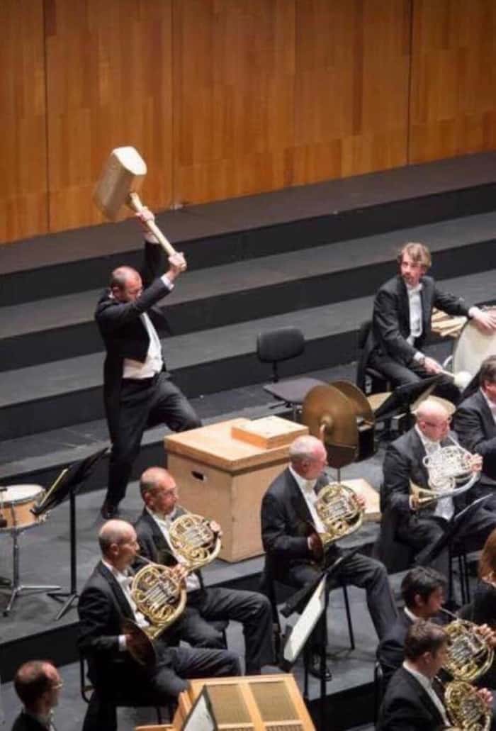 orchestra-man-with-a-wooden-hammer-confusing-photos