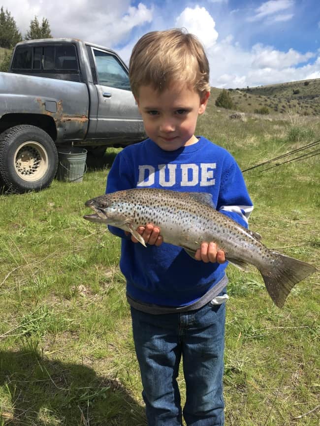 son-caught-fish-for-father-proud-parents