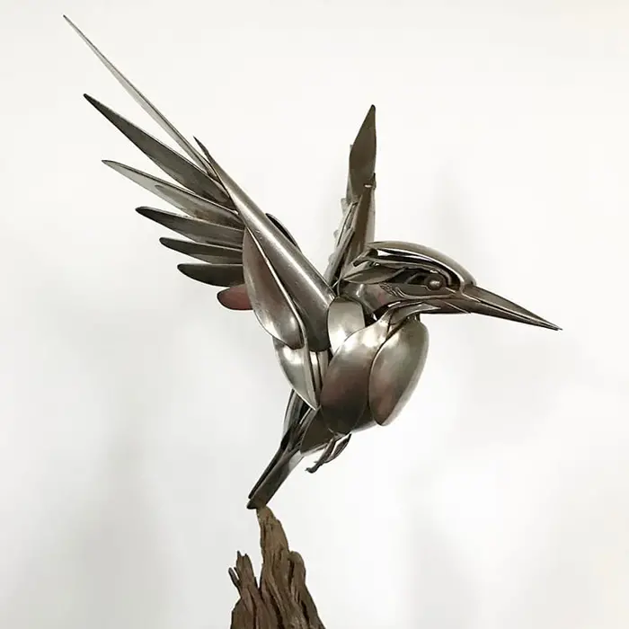 metal bird sculpture flying