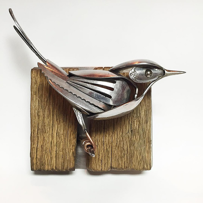 metal bird sculpture wooden perch
