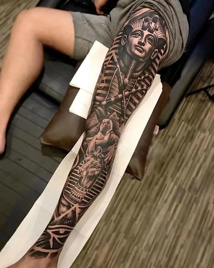 egyptian-themed epic leg tattoos