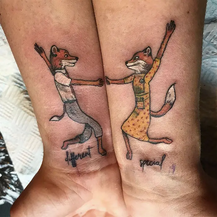 matching tattoos couple dancing foxes