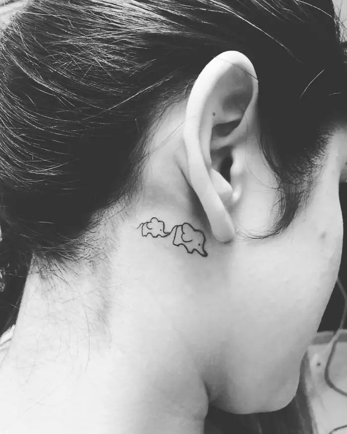 Elephant inside boa tattoo on the back of the neck