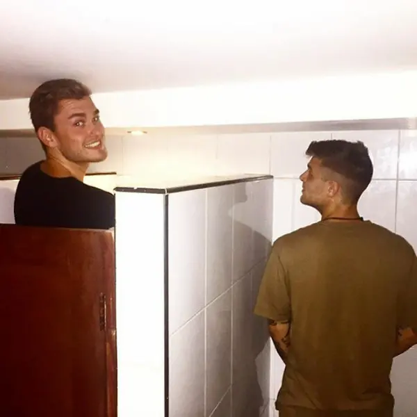tall people struggles bathroom cubicle